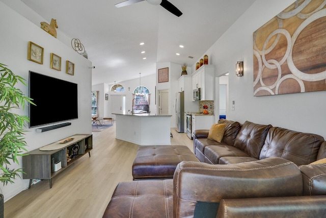 living area featuring light wood finished floors, ceiling fan, high vaulted ceiling, and recessed lighting