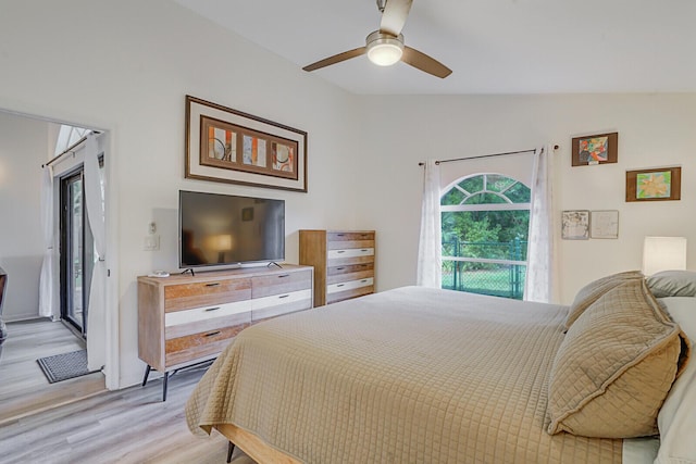 bedroom featuring light wood-style floors, vaulted ceiling, and a ceiling fan