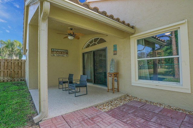 view of patio / terrace featuring ceiling fan and fence