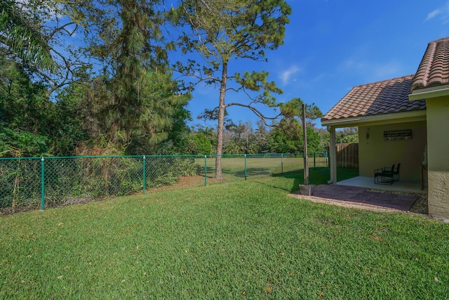 view of yard featuring a patio area and a fenced backyard