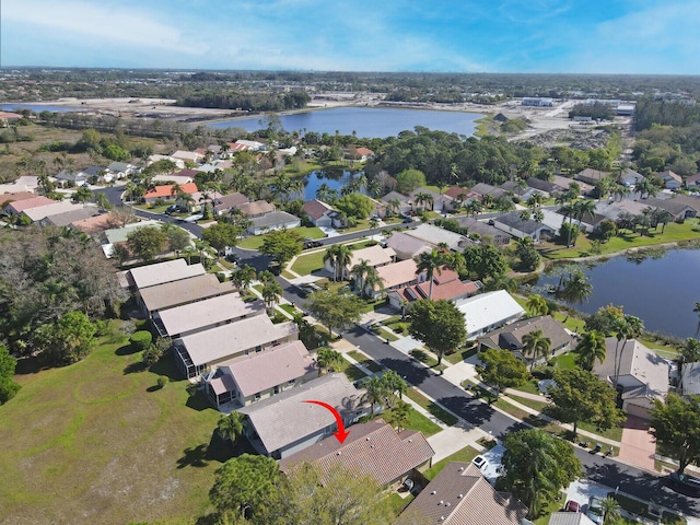 drone / aerial view with a residential view and a water view