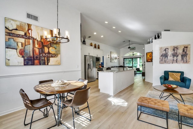 dining room with vaulted ceiling, light wood-style flooring, visible vents, and a notable chandelier