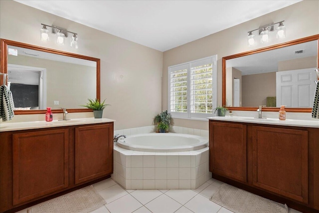 bathroom featuring vanity, tiled bath, and tile patterned floors