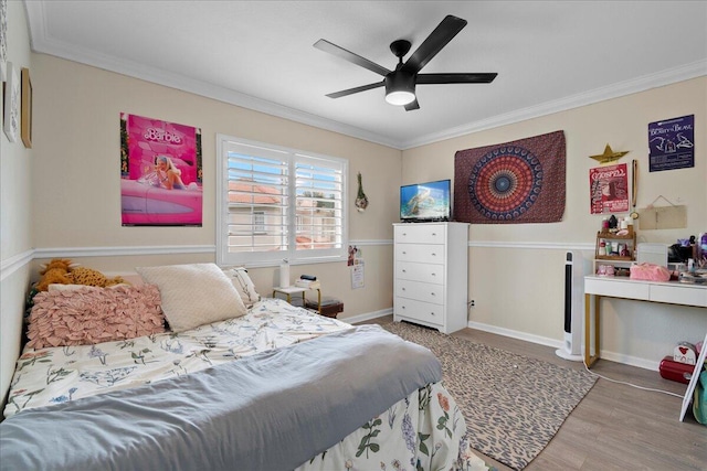 bedroom featuring crown molding, ceiling fan, and wood-type flooring