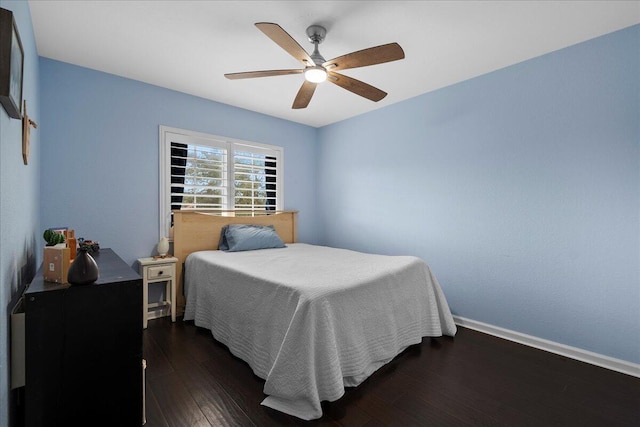 bedroom with dark hardwood / wood-style floors and ceiling fan