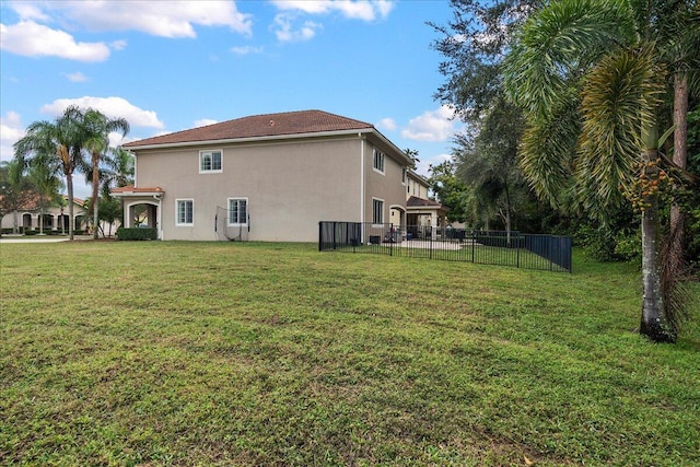 rear view of property featuring a yard