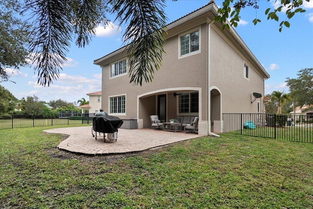 back of house with a lawn and a patio