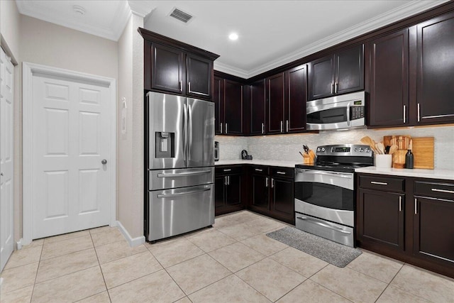 kitchen with light tile patterned flooring, appliances with stainless steel finishes, backsplash, dark brown cabinetry, and crown molding