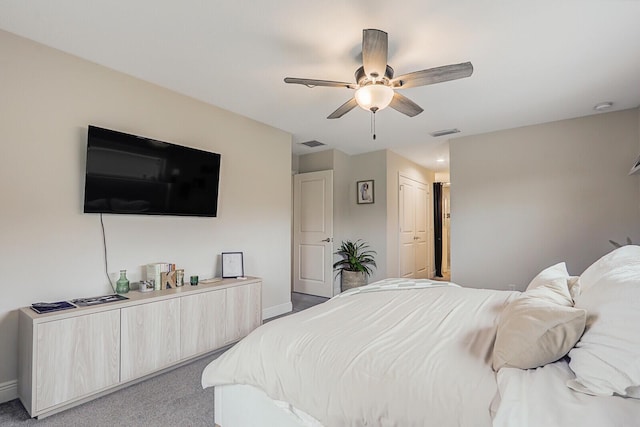 bedroom with light colored carpet, ceiling fan, and a closet