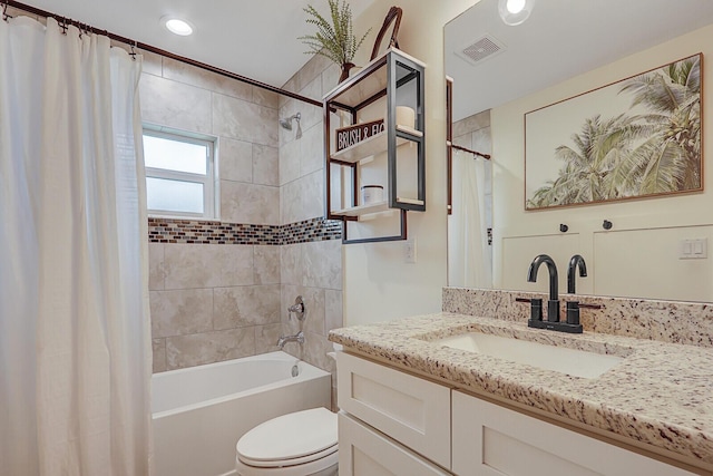 full bathroom with shower / tub combo, vanity, and toilet