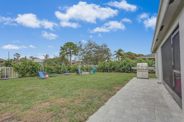 view of yard with a patio and a playground