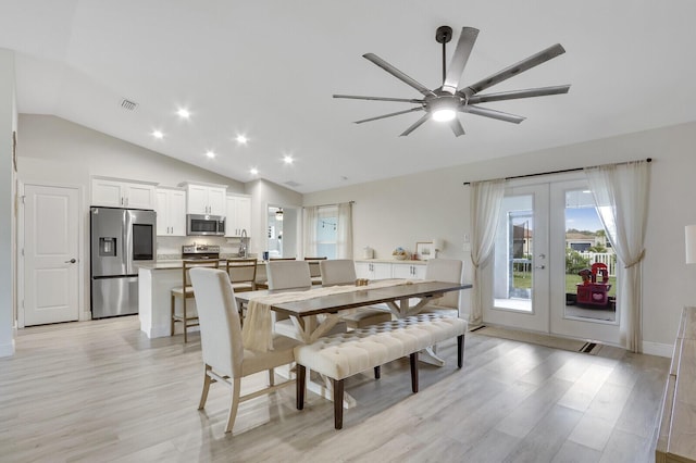 dining room featuring ceiling fan, light hardwood / wood-style floors, and lofted ceiling