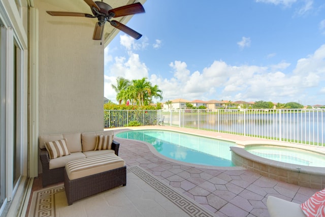 view of pool with a water view, ceiling fan, an in ground hot tub, and a patio area