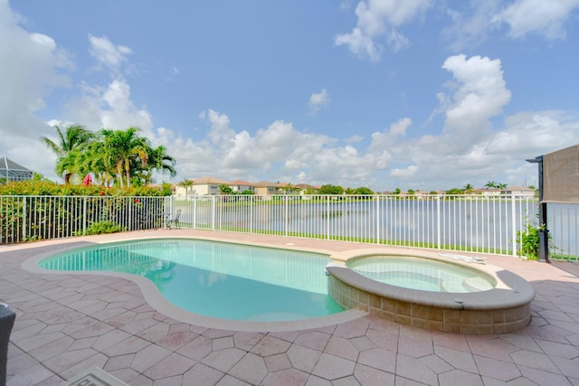 view of pool featuring a water view, an in ground hot tub, and a patio area