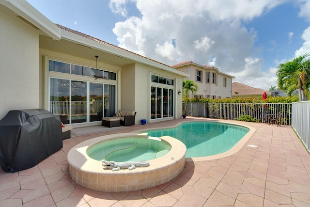 view of pool featuring an in ground hot tub, grilling area, and a patio area