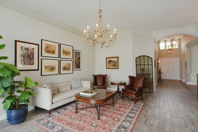 living room with an inviting chandelier and hardwood / wood-style floors