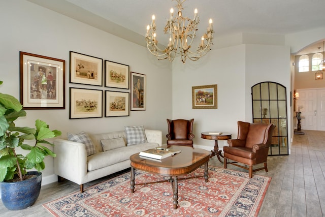 living room featuring a chandelier and hardwood / wood-style floors