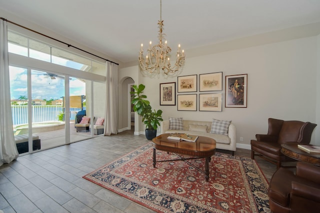 living room featuring an inviting chandelier and a water view