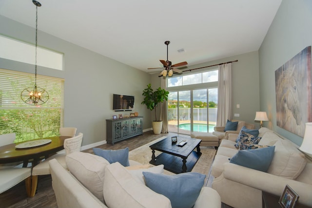 living room featuring wood-type flooring and ceiling fan with notable chandelier