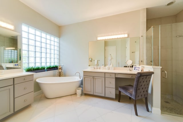 bathroom featuring vanity and shower with separate bathtub