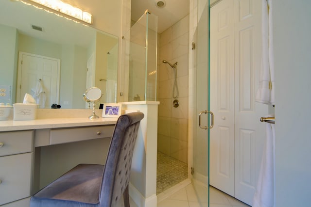 bathroom with vanity, an enclosed shower, and tile patterned flooring