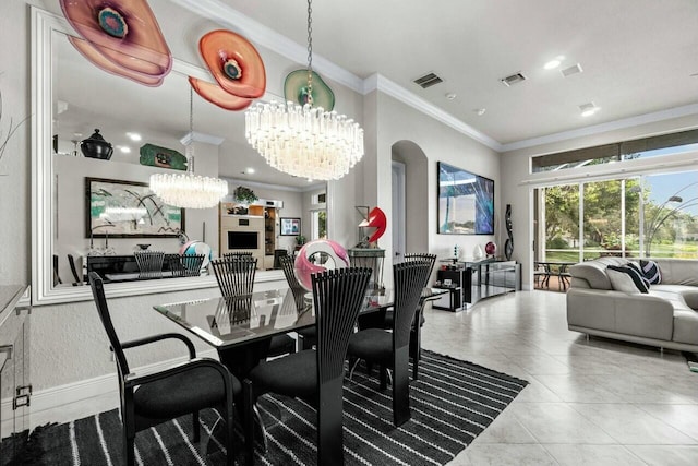 tiled dining room featuring a chandelier and ornamental molding