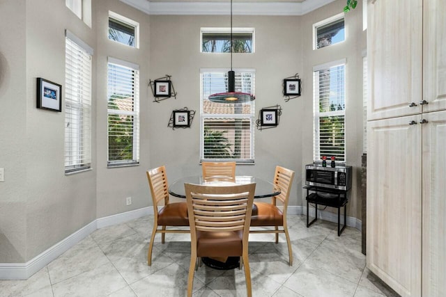 dining area featuring light tile patterned floors and crown molding