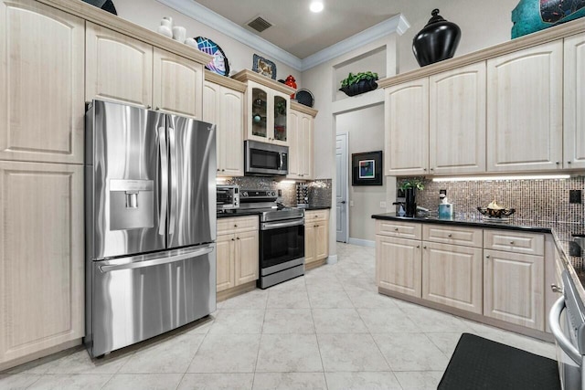 kitchen with appliances with stainless steel finishes, light brown cabinets, tasteful backsplash, light tile patterned floors, and crown molding