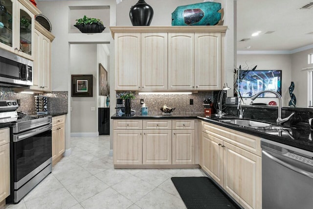 kitchen featuring light tile patterned floors, appliances with stainless steel finishes, backsplash, light brown cabinets, and sink