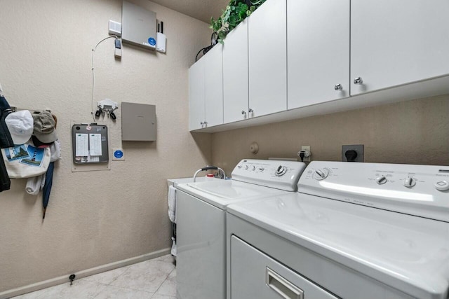 laundry room featuring cabinets and washer and clothes dryer