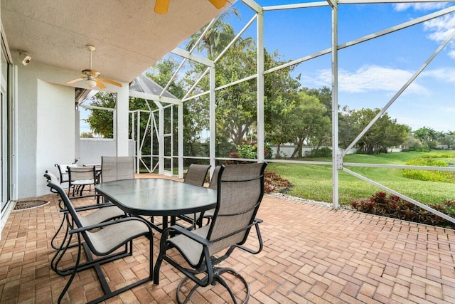 unfurnished sunroom featuring ceiling fan