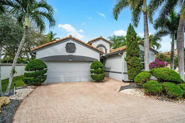 mediterranean / spanish house with a garage