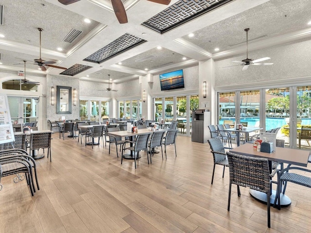 dining room featuring french doors, crown molding, coffered ceiling, and a textured ceiling