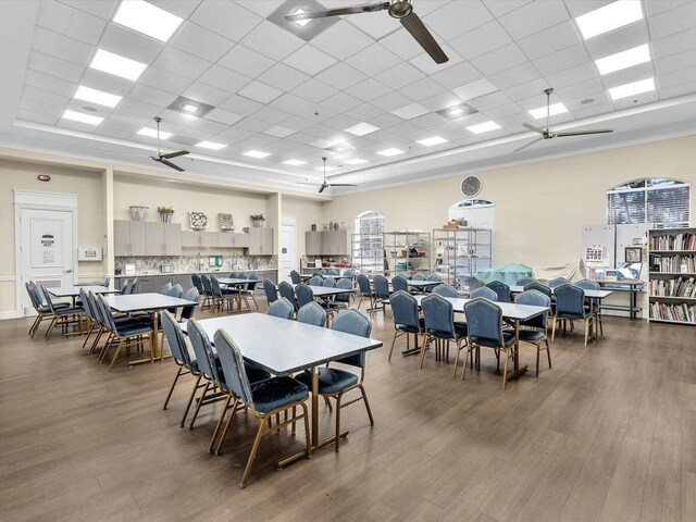 dining room featuring ceiling fan, a paneled ceiling, and hardwood / wood-style flooring