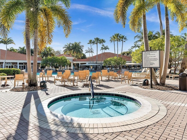 view of swimming pool featuring a hot tub