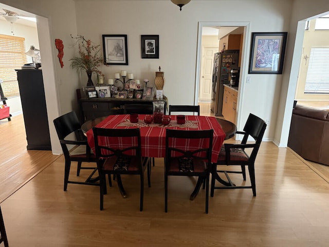 dining area with plenty of natural light and light hardwood / wood-style floors