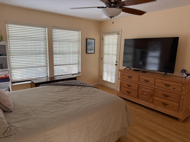 bedroom with access to exterior, light hardwood / wood-style flooring, and ceiling fan