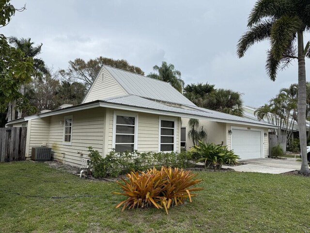 exterior space featuring a lawn and a garage