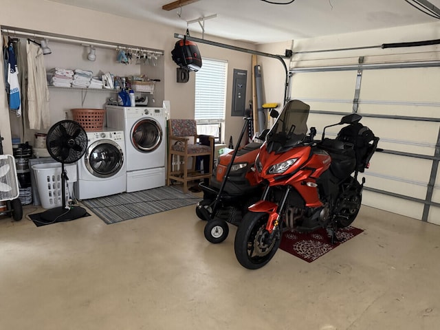 garage featuring washing machine and clothes dryer and electric panel