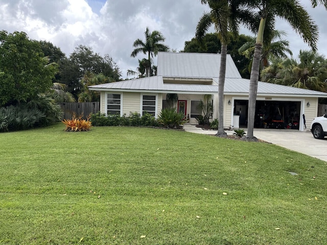 view of front of home featuring a garage and a front lawn