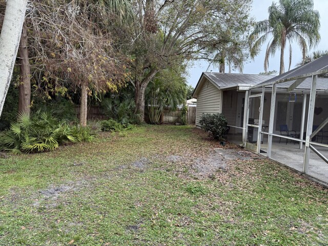 view of yard with a lanai and a patio