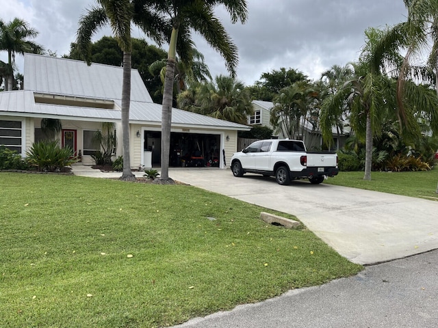 view of front of home with a garage and a front lawn