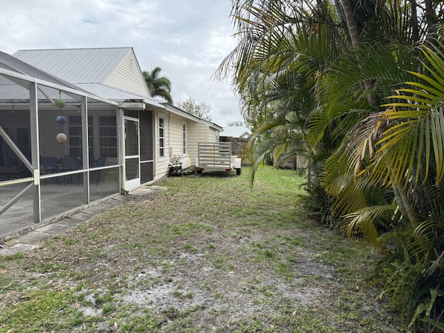 view of yard featuring glass enclosure