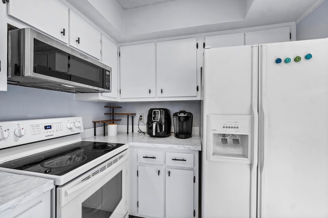 kitchen with white appliances and white cabinetry