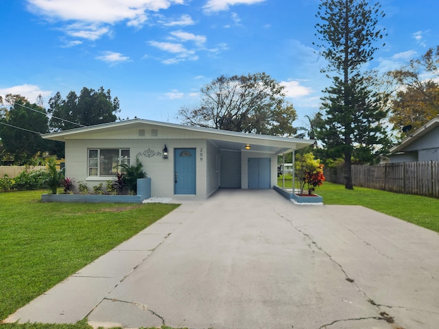 view of front of property with a front lawn and a carport