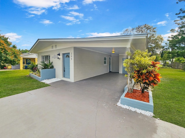 view of front facade with a front yard and a carport