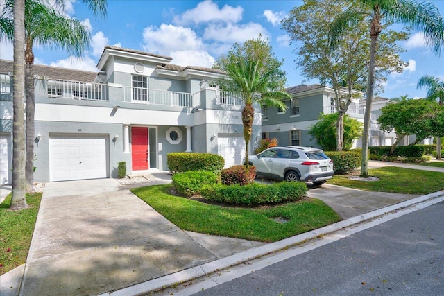 view of front of property with a balcony and a garage