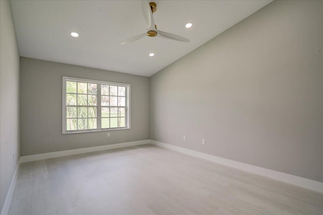 unfurnished room with ceiling fan, light hardwood / wood-style flooring, and lofted ceiling