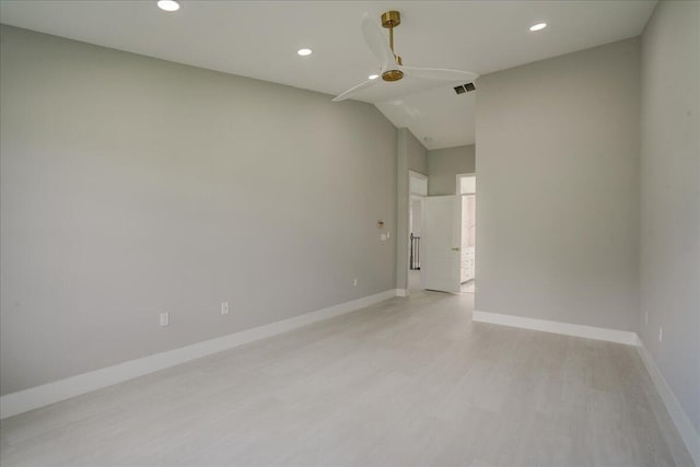 unfurnished room with light wood-type flooring and lofted ceiling