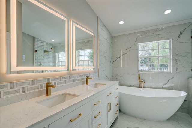 bathroom featuring decorative backsplash, tile walls, vanity, and separate shower and tub